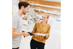 Image Sanna Fager, chief commercial officer at PulPac with worker holding a tray.